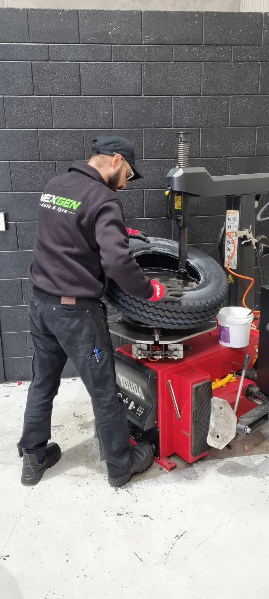 Mounting a tyre on the Youda machine at NexGen Hamilton
