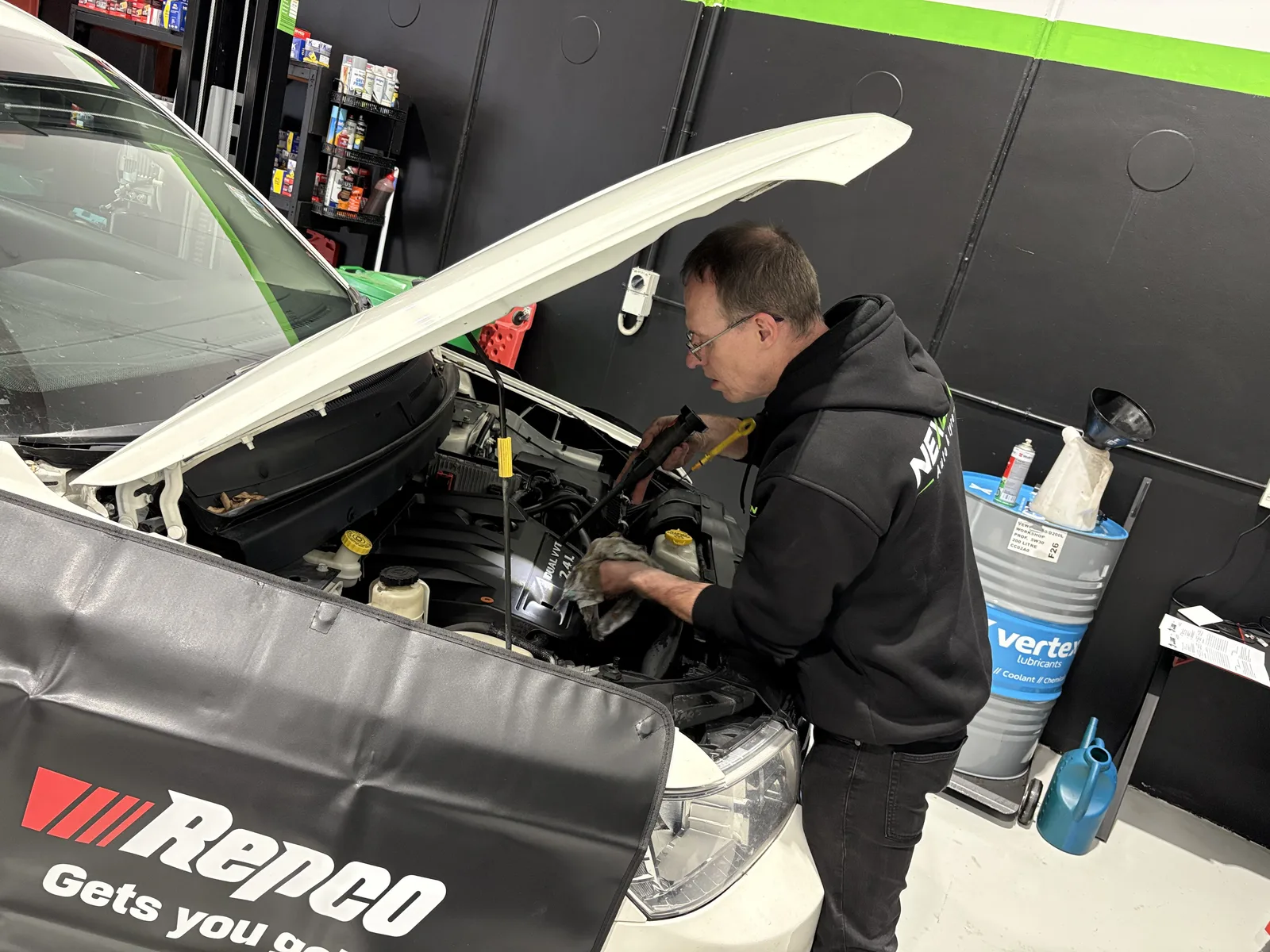 NexGen technician checking the oil dipstick on a Dual VVTi engine