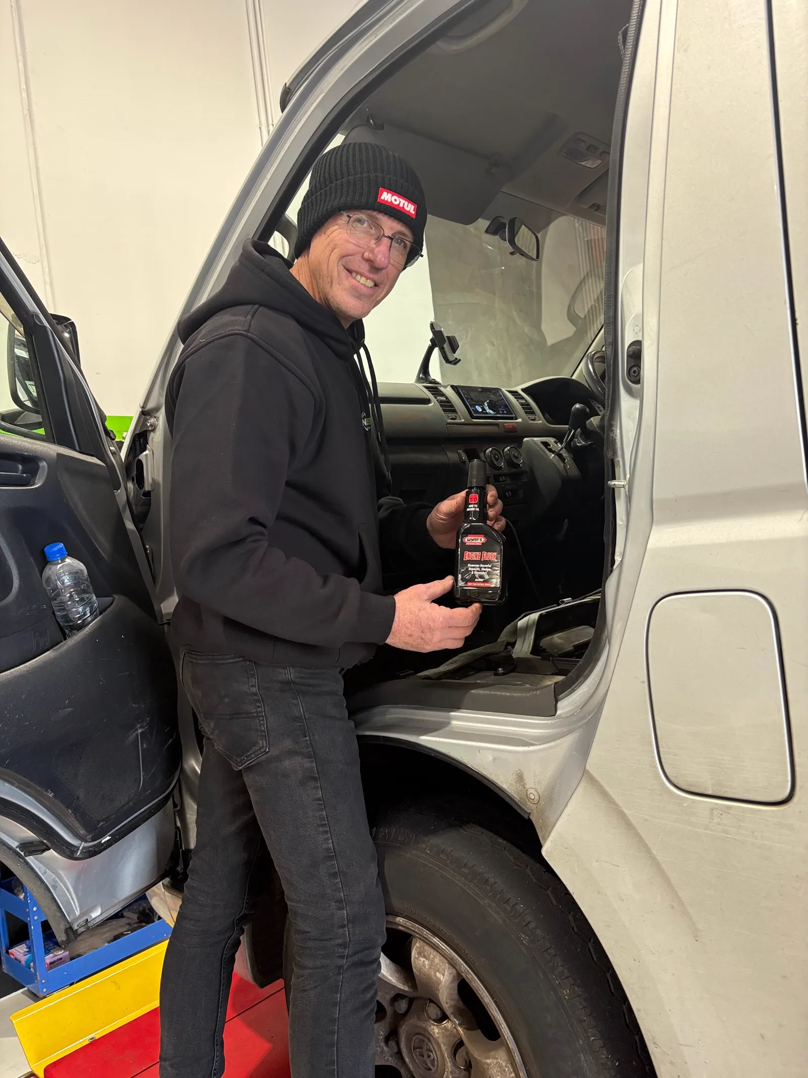 NexGen technician with Wynn's engine flush before an oil service