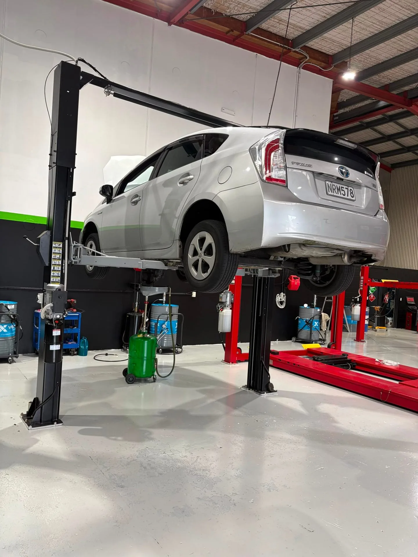 Toyota Prius raised on hoist during oil service
