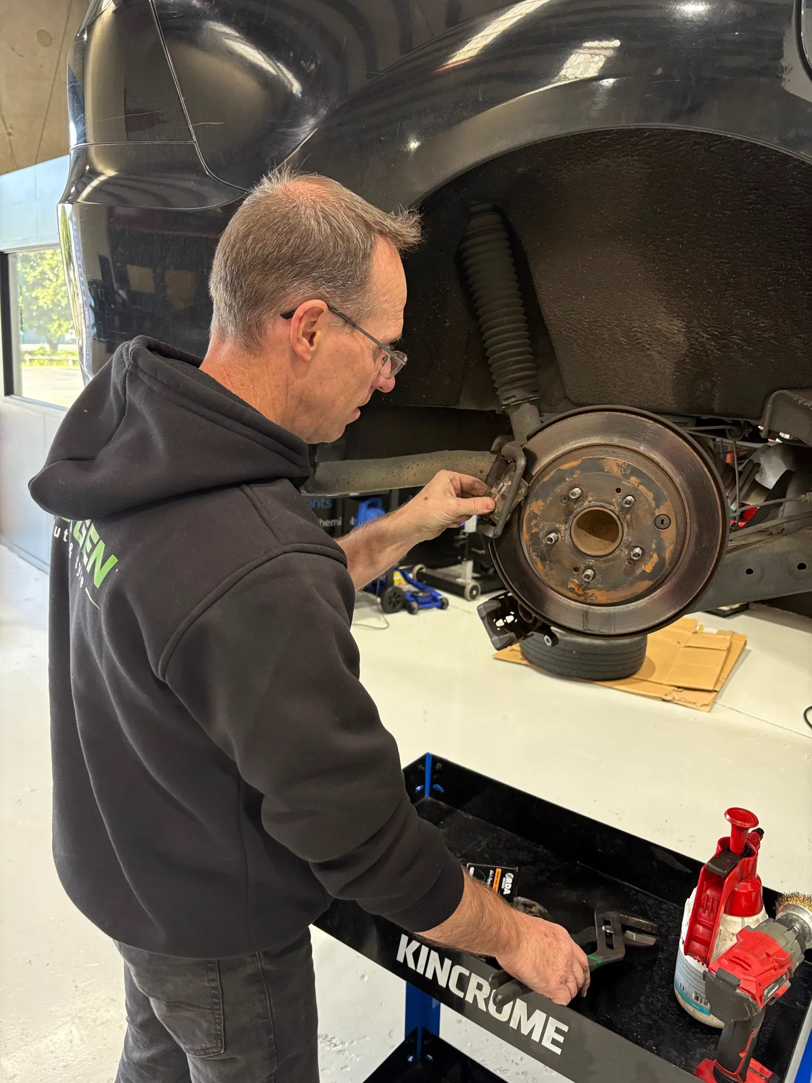 Rear brake inspection with rotor and caliper exposed