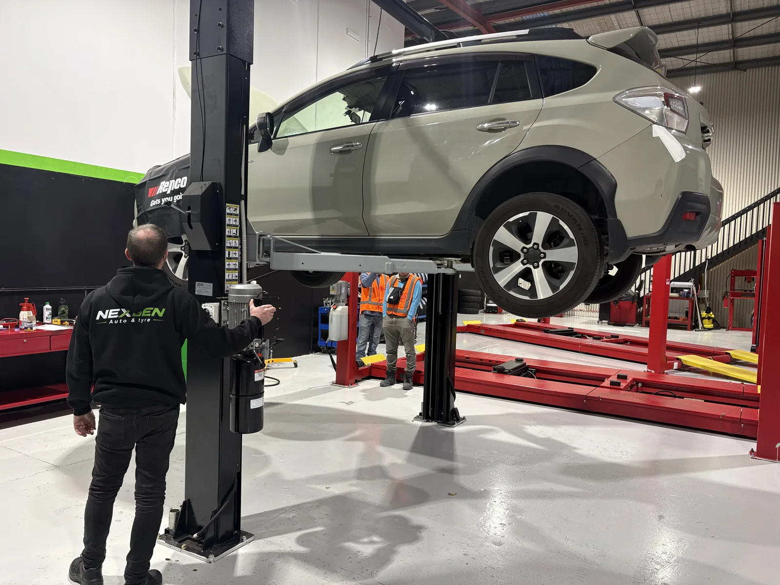 Subaru XV lifted on the NexGen two-post hoist during a service